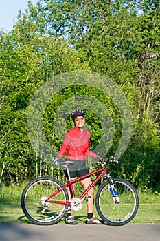 Woman Standing Next to Bicycle - Vertical