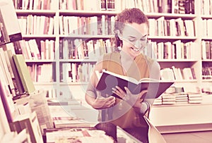 Woman standing with open in publishers store