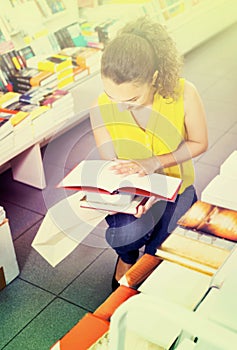 Woman standing with open in publishers store photo