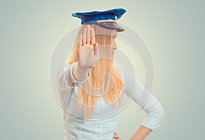 Woman standing with outstretched hand showing stop, no gesture.