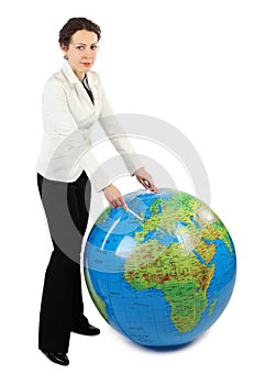 Woman standing and pointing at Europe on globe