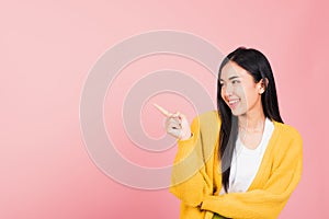 Woman standing pointing finger side away presenting product