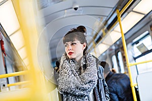 Woman standing in public transportation