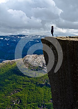 Woman standing on Pulpit Rock Preikestolen Norway