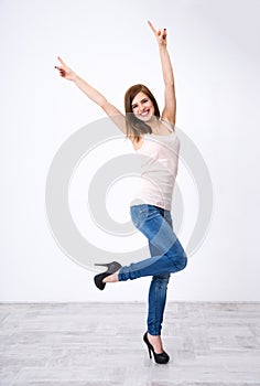 Woman standing with raised hands up