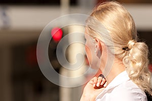 Woman standing at red traffic light