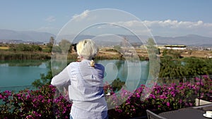 Woman standing on a restaurant patio enjoying the view