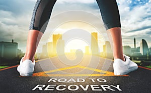 Woman standing on Road to recovery concept for business and health concept with golden city background