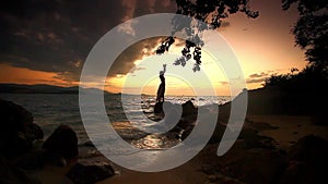 Woman standing on rock and looking to the horizon