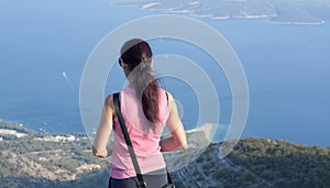 Woman standing on the rocks of Vidova Gora, the mountain of Saint Vid, BraÄ island in Croatia, Mediterrane