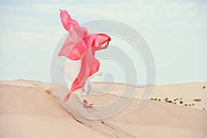 Woman standing in sand dunes