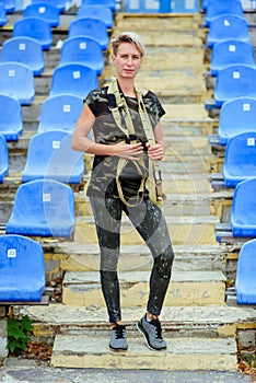 Woman  standing on the steps of the stadium, goes to training outdoors