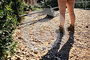 Woman standing on stony ground.