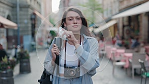 Woman standing on street and taking off medical mask