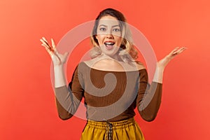 Woman standing surprised with open mouth and raised hands