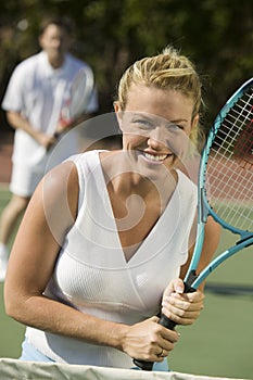 Woman standing at Tennis Net waiting for serve portrait