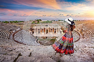 Woman standing on theater of Hierapolis ancient city in Pamukkale, Turkey.