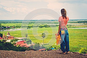 Woman standing on top of a hill enjoying Floating village view, Phnom Krom, Siem Reap, Cambodia