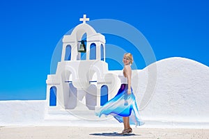 Woman standing by the traditional greek church