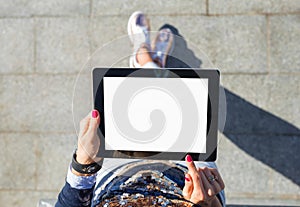 Woman standing and using blank screen tablet