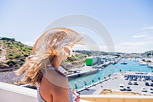 Woman standing at viewpoint over, the Porto de Abrigo de Albufeira, Albufeira Bay in Albufeira, Portugal