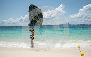 Woman standing in water at edge of beach