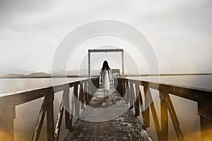 Woman standing at water level gate horror scene