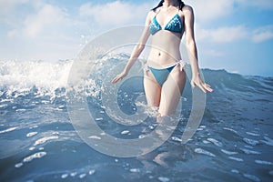 Woman standing in waves at beach