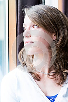 Woman standing by a window