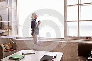 Woman Standing At Window And Looking At Beautiful Beach View