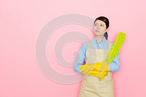 Woman standing with yellow feather stick