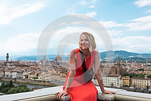 Woman stands against the backdrop of the panorama of Florence, Italy.