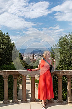 Woman stands against the backdrop of the panorama of Florence, Italy.