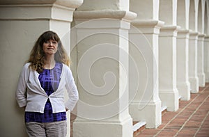 A Woman Stands Amid Spanish Revival Style Architecture