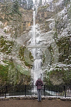Woman Stands Below Multnomah Falls