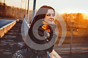 A woman stands on a bridge