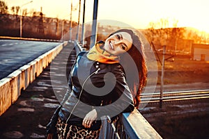 A woman stands on a bridge