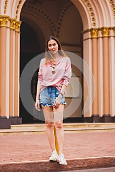 The woman stands beside the church entrance.