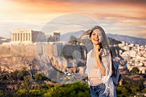 Woman stands in front of the Acropolis of Athens, Greece