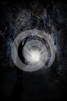 Woman Stands Inside Tunnel With Blinding Light