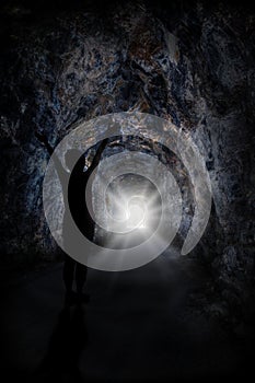 Woman Stands Inside Tunnel With Blinding Light photo