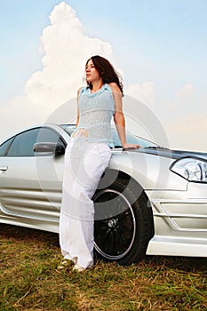 Woman stands near sport car