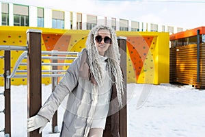 Woman Stands Next to Fence in Snow