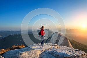 Woman stands on the peak of stone in Bukhansan national park.