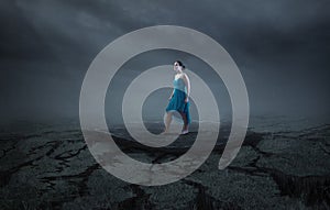 A woman stands on a solid rock