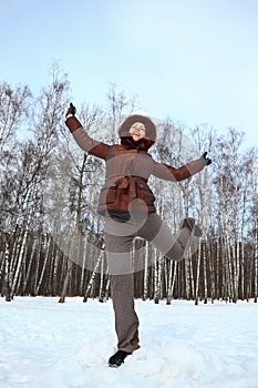 Woman stands on to snow and gravitate skyward