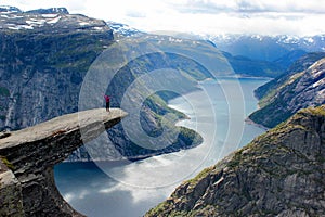 A woman stands on Trolltunga, Norway