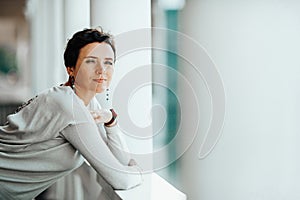 A woman stands on the waterfront of the port