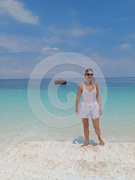 Woman stands at exotic beach whitesand