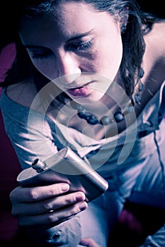 Woman staring at flask